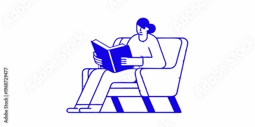 A person is peacefully reading a book while sitting in an armchair