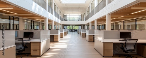 Bright, modern open-plan office featuring a central atrium, symmetrical rows of cubicles and integrated natural and linear lighting. Contemporary workplace design. Office, Architecture