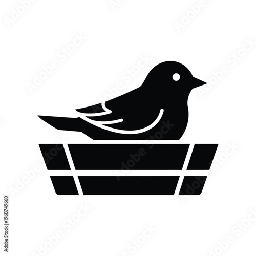 Minimalist black bird silhouette sitting in a protective nest, symbolizing nature, spring, and the comfort of home.
