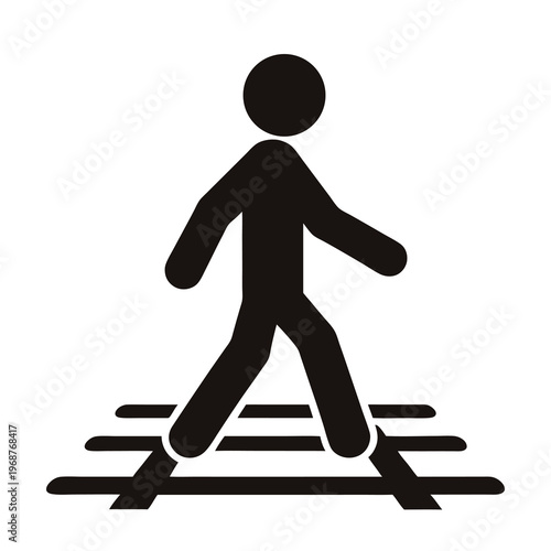 Silhouette of a person walking on railway tracks suggests trespassing danger
