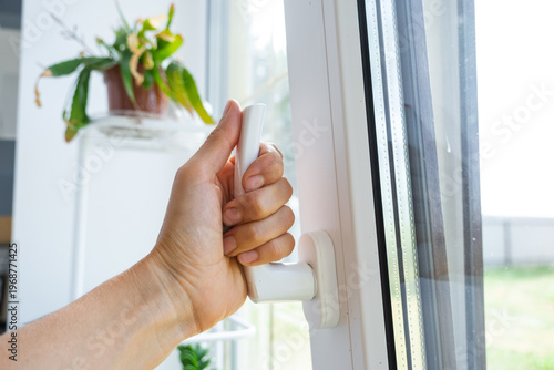 Foto Plastic window ajar for micro-ventilation, privacy handle, draft protection, fresh air, sound insulation, reliable hardware, business-quality installation