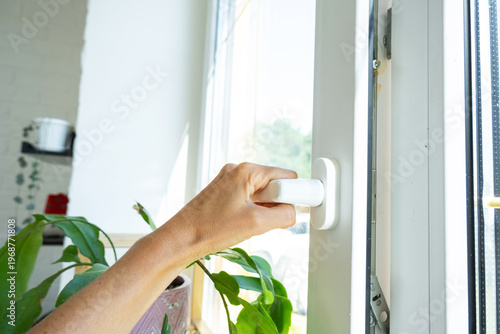 Fotografia Professional adjustment of window hardware for smooth opening and improved airing, draft prevention, branded double glazing, and business-level installation