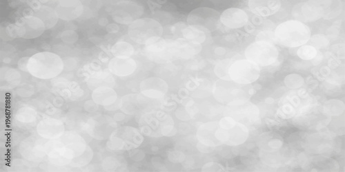 Abstract bokeh background featuring bright blue holiday glitter and silver snow patterns with a soft winter glow and defocused Christmas decoration lights