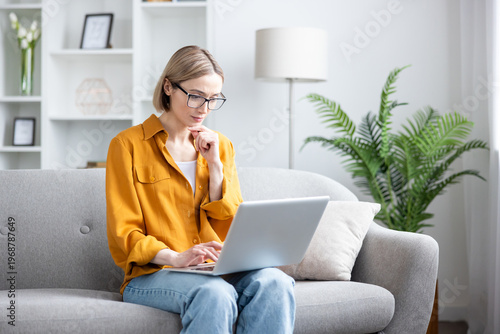Woman working on laptop from home, remote work
