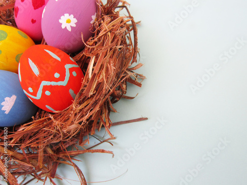       Happy Easter! Modern painted eggs inside the nest.                         