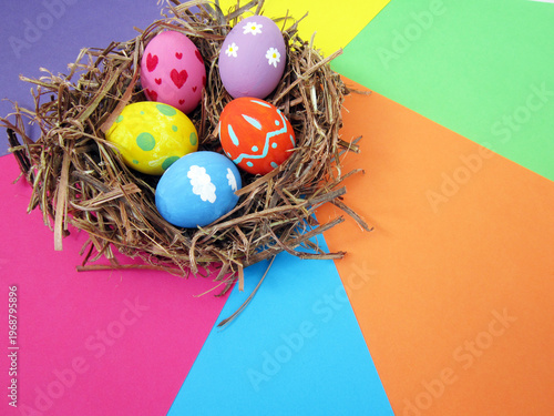    Happy Easter! Modern painted eggs inside the nest.                            