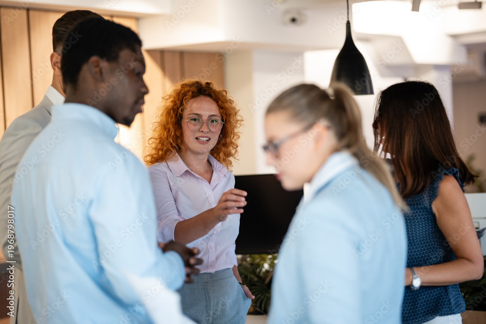 Fototapeta premium Diverse business team engaged in active workplace discussion