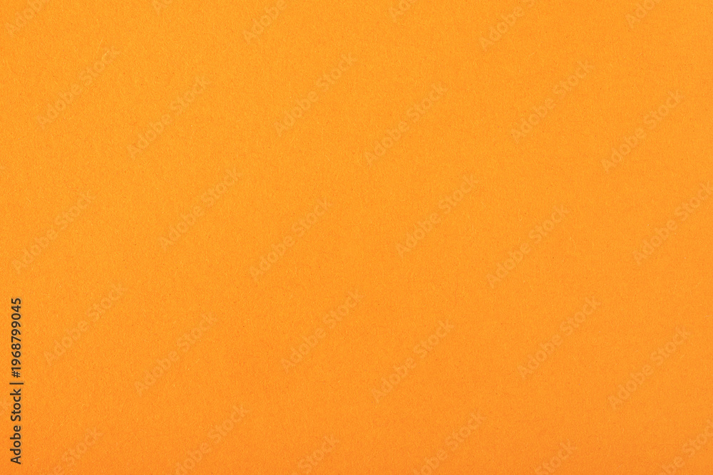 Fototapeta premium Bright orange textured paper background, ideal for creative designs, crafts, invitations, and digital presentations.