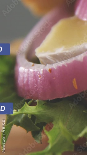 Vertical video: Lettuce onion rings cheese sitting as alert firing and badges floating over food PR