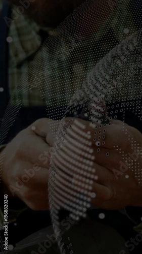 Male maker picking small object at bench, dotted overlay partly obscuring hands while shaping form