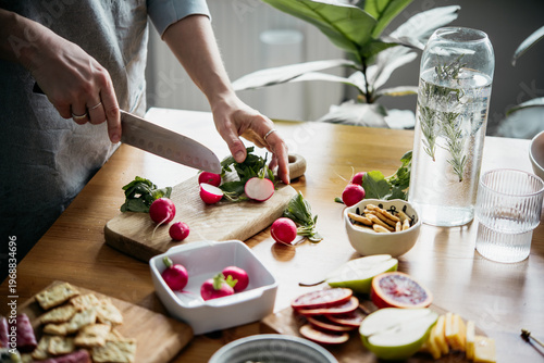 Cutting vegetables while cooking dinner. Healthy eating at home concept.