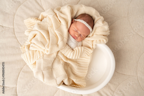 Sleeping newborn wrapped in soft blanket