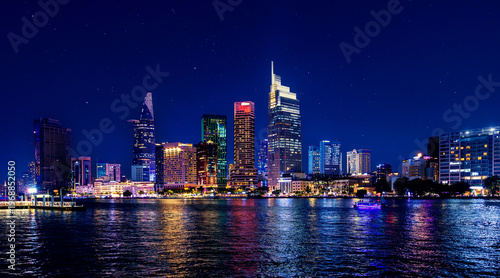 Cuadro en lienzo Coastline with skyscrapers of Ho chi minh or Saigon city in Vietnam, night panor