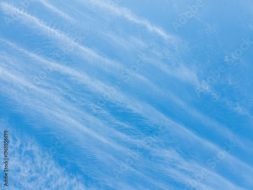 Whispering cloud formations dance gracefully over an endless azure expanse