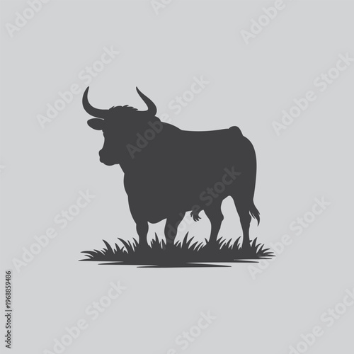 Silhouette of a bull standing in grass