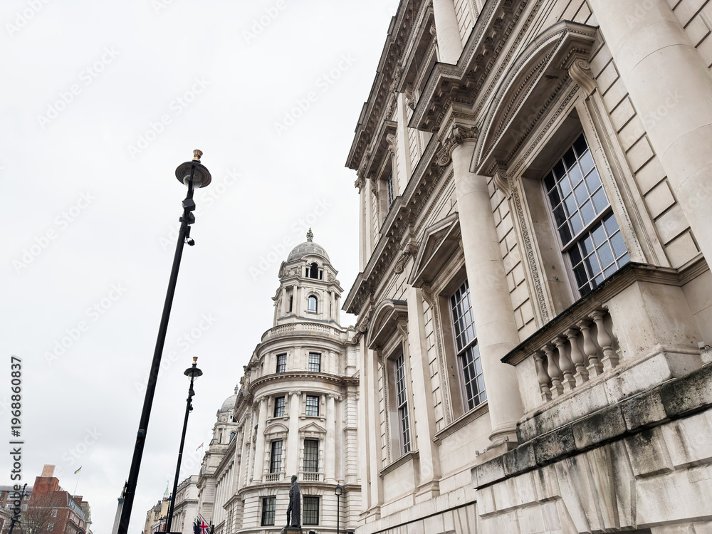 Fototapeta premium Neoclassical Old War Office Building government building facade and street lamps in central London, UK cityscape
