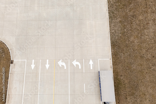 Top down view of road markings and white arrows