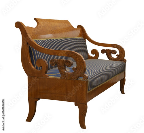 Elegant vintage wooden sofa with intricate carvings and striped upholstery in warm tones