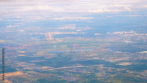 Flying high above Moscow. View of the airport from above. Airplane window
