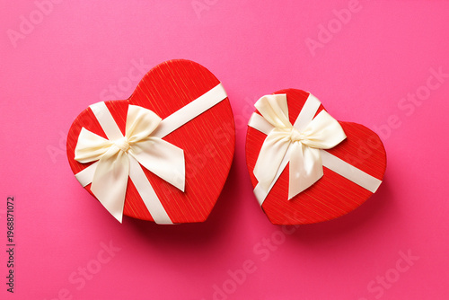 Beautiful heart shaped boxes on pink background, flat lay