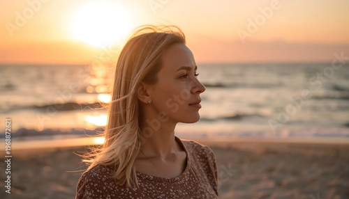 Portrait of a woman on a beach at sunset, bathed in warm light with ocean background. She has blond hair, looking wistful