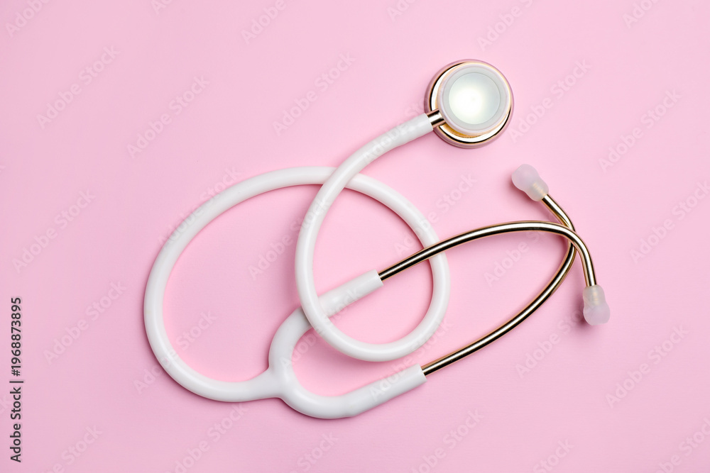 Fototapeta premium Stethoscope on pink background, top view. Medical equipment