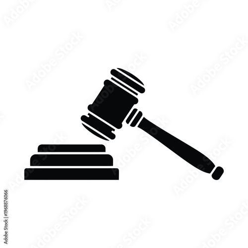 A gavel rests on a block in a courtroom setting indoors.