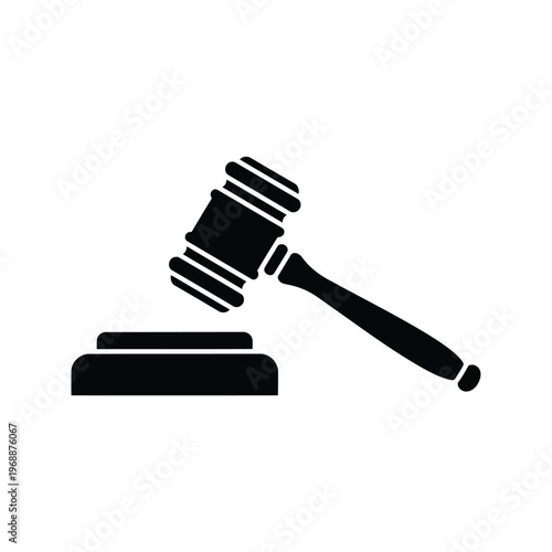 A gavel rests on a sound block in a courtroom setting.