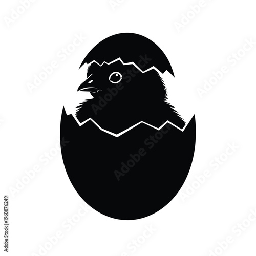 A bird emerges from a broken eggshell cracking open.