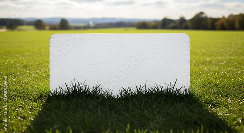 White wooden sign board standing in green grass field landscape with trees in distance transparent background