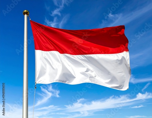 Red-white flag on silver pole, waving against blue sky with wispy clouds