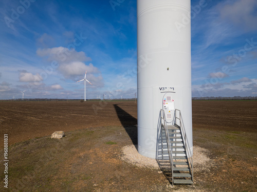 Photography Aerial View of Wind Turbine Base and Entrance in Rural Field