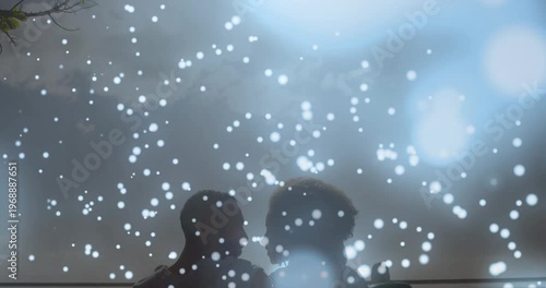 Glowing blue spots of light falling over african american couple embracing each other at the beach