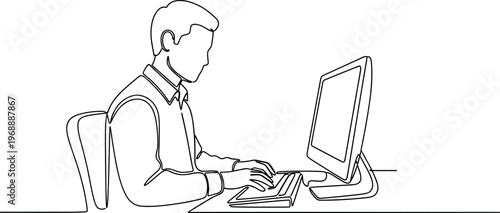 A man works intently on his computer in a modern office setting.