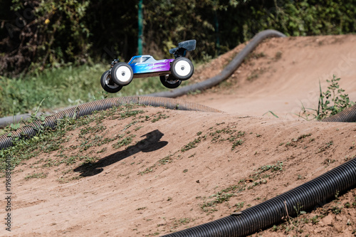 Cuadro en lienzo Radio-controlled car jumping on dirt track