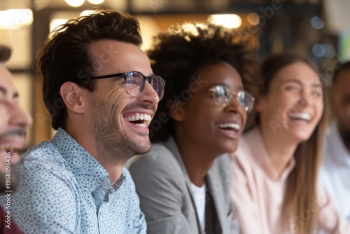 A group of diverse friends laughs together in a casual setting.