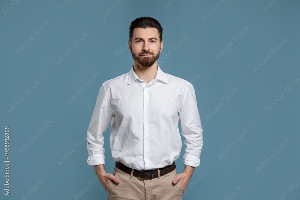 Obraz premium Portrait of handsome man on light blue background