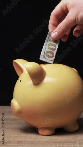 Hand Placing Cash Into Piggy Bank, Closeup Of Adult Hand Inserting Folded Banknote Into Yellow Ceramic Pig