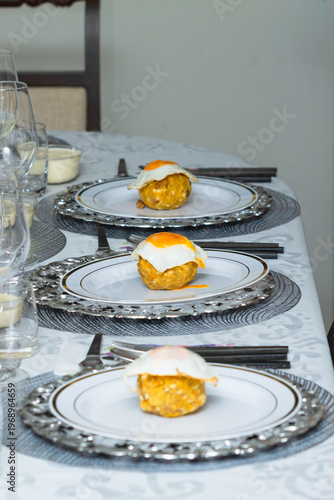 Three Ecuadorian green plantain bolones with eggs served on plates, ready to eat, traditional food