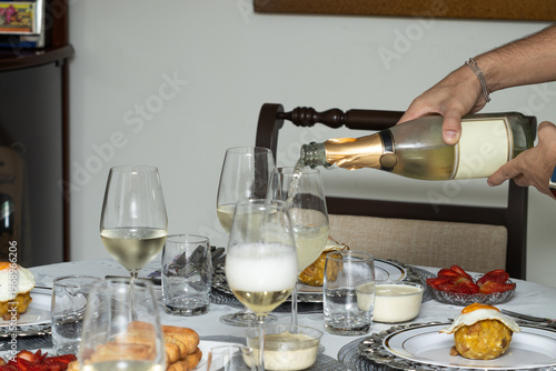 Pouring sparkling wine into glassware on formal dining table, celebration and social event concept