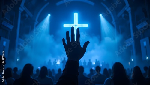 A silhouetted human hand raised upward in worship and prayer, reaching toward a glowing neon blue cross in the background