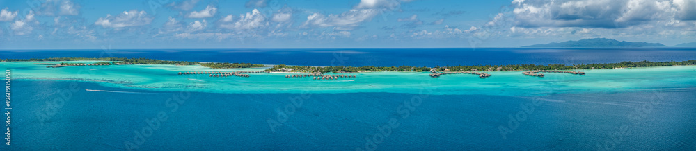 Fototapeta premium panoramic aerial landscape view of parts of Piti Aau and Motu Piti A'au Atoll as part of Bora Bora island with resorts and bungalows in bright turquoise blue water and Taha'a Island in the background