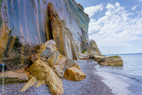 Bild auf Leinwand Towering cliffs meet gentle waves at this coastal beach