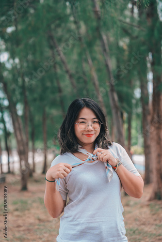 young gril Asian people enjoys a moment of relaxation in a sea  and nature. His happiness and self-love shine through as he embraces the peaceful outdoors.