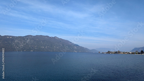 Majestic Mountain Lake Landscape with Charming Village and Cloudy Blue Sky View