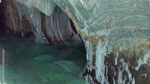 Witness the breathtaking beauty of the Marble Caves in Patagonia. Azure waters gently lap against swirling, sculpted marble walls, revealing natures artistic handiwork.
