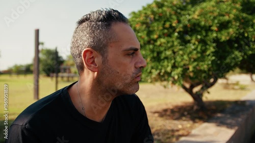 man blowing air to get rid of flies