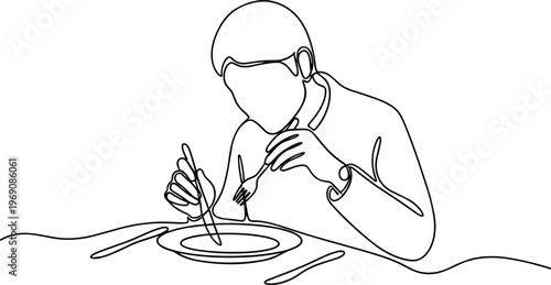 Man eating with utensils at table.