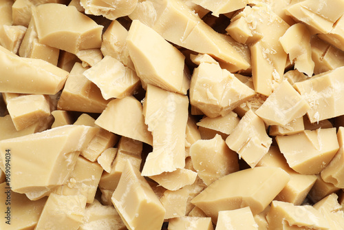 Cuadro en lienzo Pieces of natural cocoa butter as background, top view