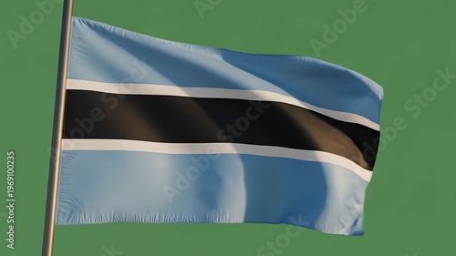 Botswana flag waving in the wind against a green screen, national symbol of Botswana, african